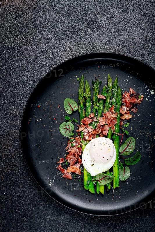 Asparagus with poached egg and fried bacon, micro greens and spices, breakfast, homemade, no people
