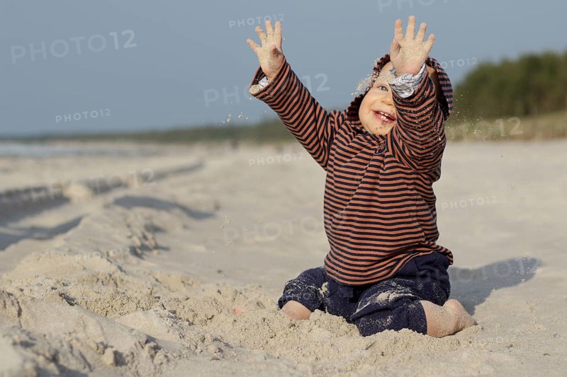 Child playing on the sandy beach. Pobierowo, Poland