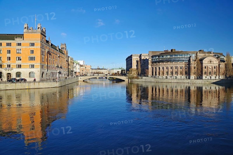 City view with river, bridge and historical buildings in the background, Riksdag, capital city, Stockholm, Sweden