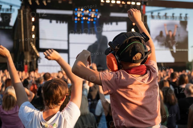 Applause of a boy with headphones during music concert