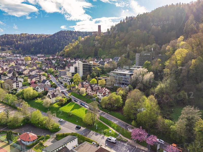 Town embedded in forest landscape with hills and blue sky, Bad Liebenzell, district of Calw, Black Forest, Germany