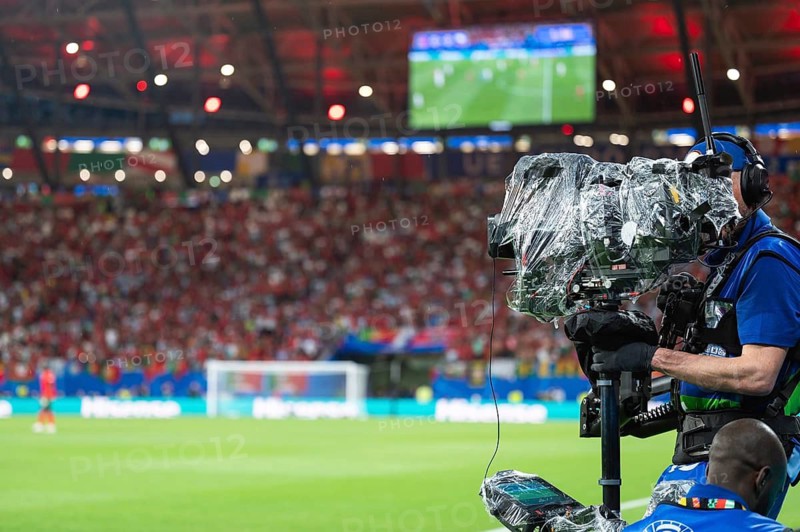 Man carries TV camera on the stabilizer at football stadium