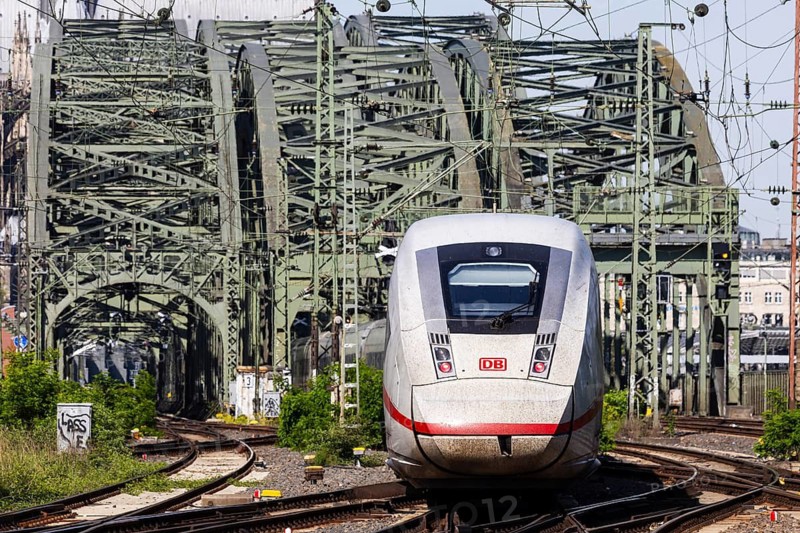 Rail traffic between Cologne-Deutz and Cologne Central Station. Hohenzollern Bridge, railway bridge over the Rhine with Deutsche Bahn ICE trains. The towers of Cologne Cathedral in the background. Cologne, North Rhine-Westphalia, Germany