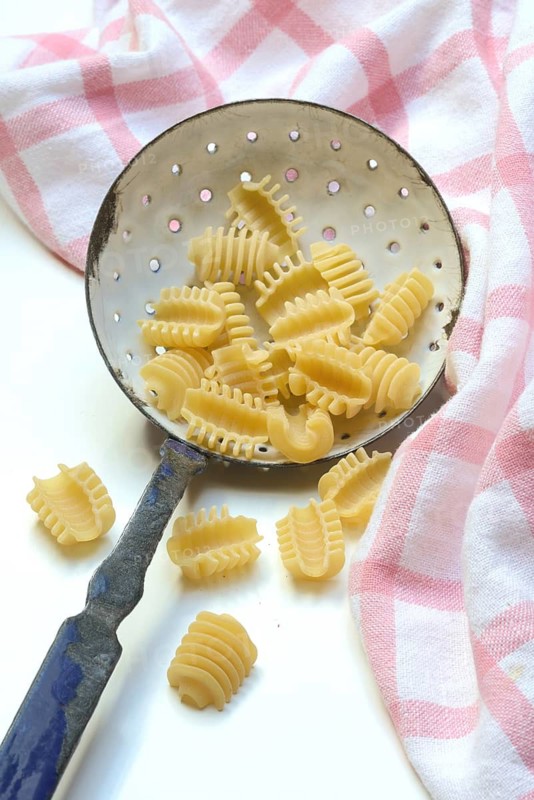 Italian pasta in a sieve, Radiatori variety