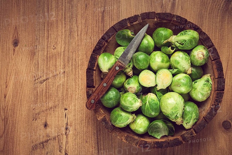 Fresh Brussels sprouts, raw, top view, on a wooden table, no people