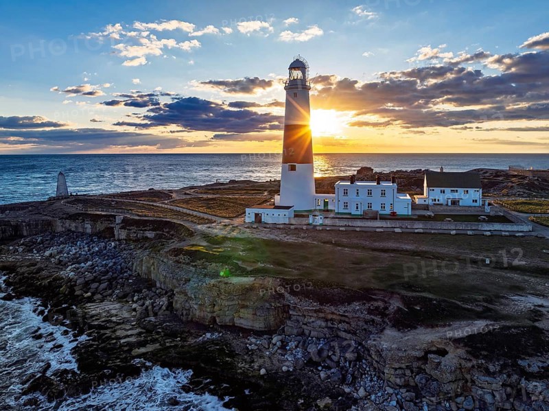 Sunset over Portland Bill Lighthouse from a drone, Portland Bill, Isle of Portland, Dorset, England, United Kingdom