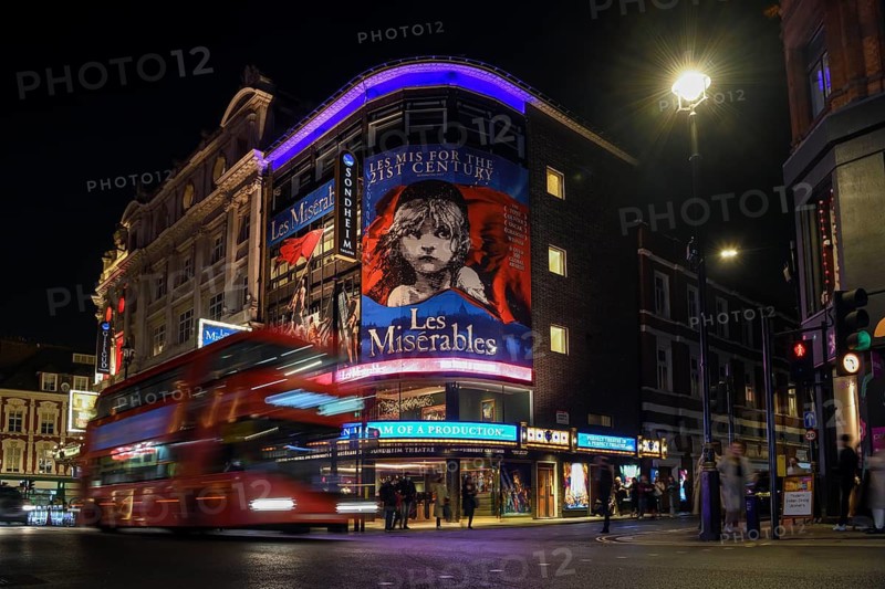 Red double-decker bus outside the Sondheim Theatre, Les Misérables, Musical, West End, London, England, United Kingdom