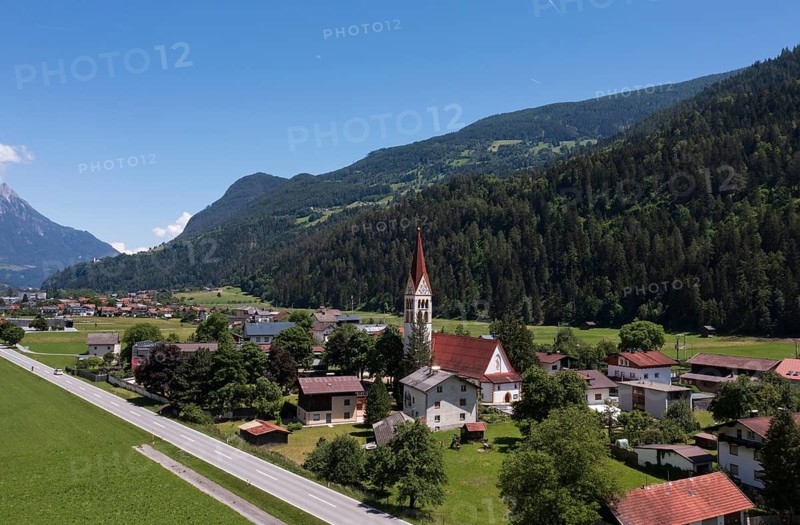 Drone shot, view of village with parish church, Schönwies, Oberinntal, Tyrol, Austria