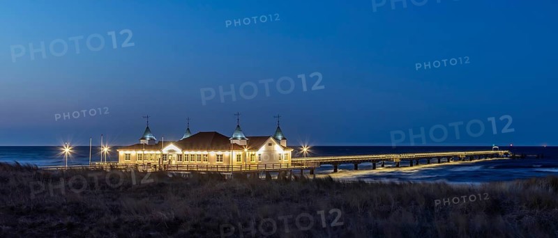 Restaurant on Ahlbeck Pier, Seebrücke Ahlbeck illuminated at dusk in the Baltic Sea on Usedom island, Mecklenburg-Vorpommern, oldest pier in Germany