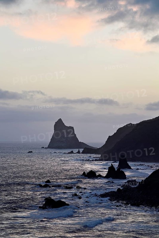 Beach of Playa de Benijo at high tide with the rock Roques de Anaga in the light of the rising sun, Tenerife, Canary Island, Spain