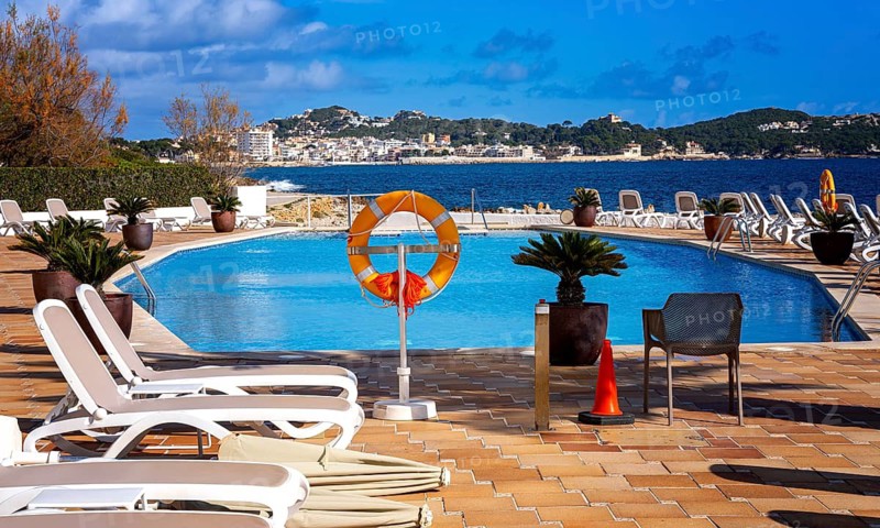 Swimming pool and sun loungers, Cala Rajada, Majorca, Spain