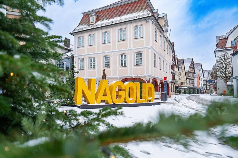 Town hall, snow-covered street with 'NAGOLD' lettering and old town houses in the background, Nagold, Black Forest, Germany
