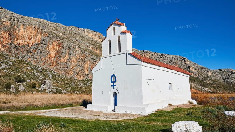 Agiou Petrou Chapel, Chapel of St Peter, A solitary whitewashed chapel stands against a mountainous backdrop, Strofilia biotope, wetlands, Kalogria, Peloponnese, Greece