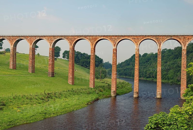 An old stone bridge with arches crossing a tranquil river in a green landscape, Aqueduct, Scottish Borders, Melrose, Scotland, United Kingdom