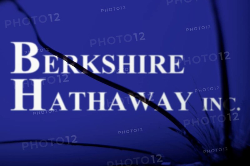 Berkshire Hathaway inc logo is visible on the broken glass. Berkshire Hathaway Inc is an American multinational conglomerate holding company.