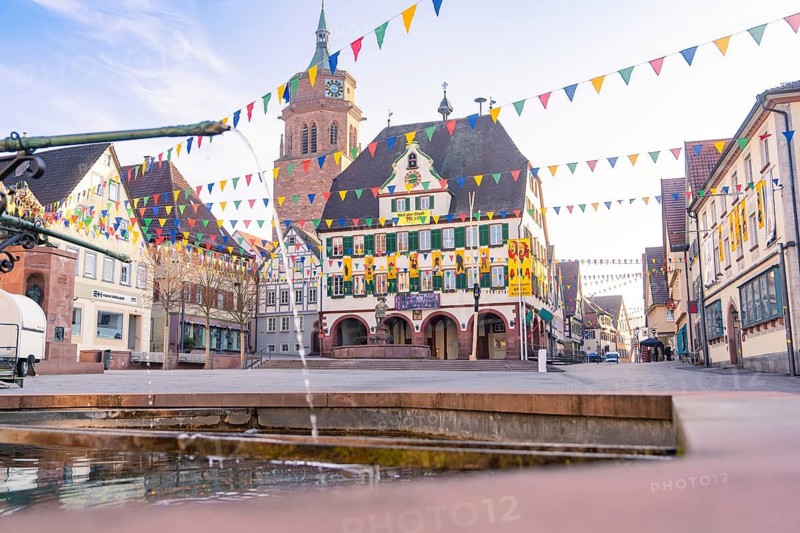 Festively decorated square with bell tower and historical charm under a clear sky, Fasnet, Weil der Stadt, Böblingen district, Germany