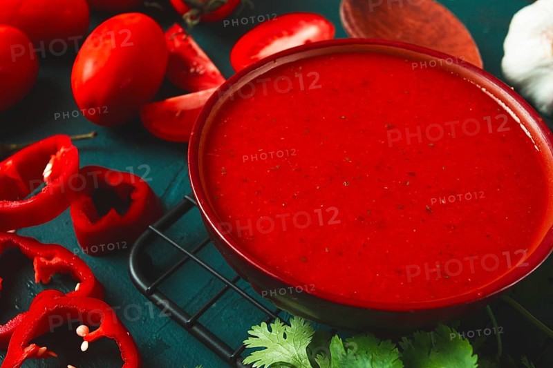 Tomato sauce, tomatoes and sweet pepper, Georgian Satsebeli sauce, with ingredients on a dark background, top view, close-up, no people
