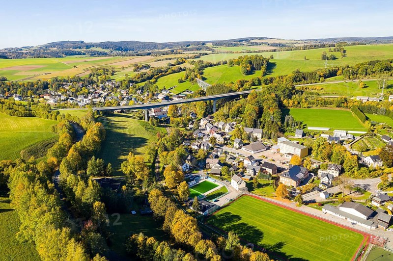 Aerial view of the village with bridge of the federal road 101 in autumn, in the background the Markersbach viaduct, Markersbach, Erzgebirge, Saxony, Germany