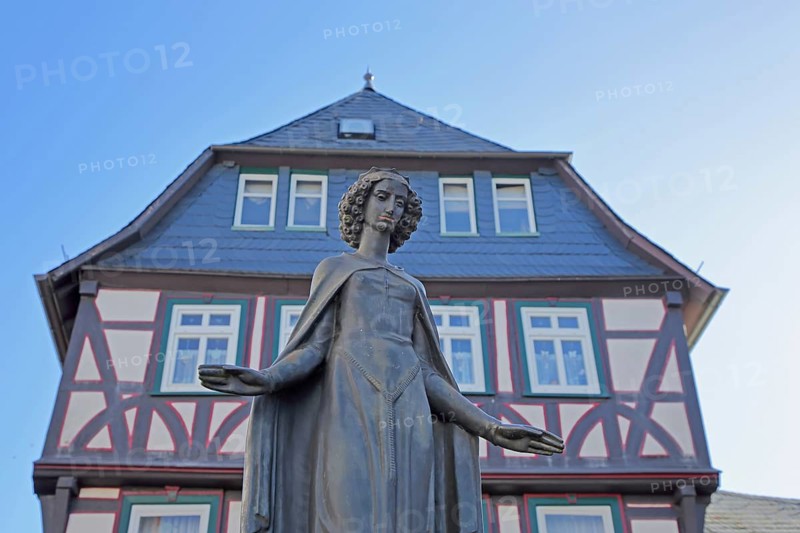 Sculpture of Saint Barbara of Nicomedia, martyr, female figure, outstretched arms with gesture, outstretched, gable of half-timbered house built 1500, fountain, iron market fountain, iron market, Wetzlar, Hesse, Germany