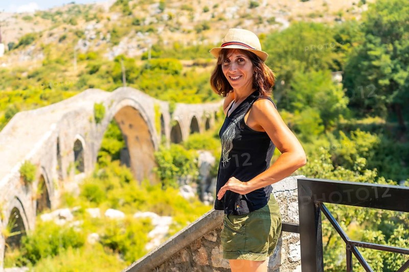 A tourist woman on the Ottoman Old Mes bridge near Shkoder. Albania, Europe. Ura e Kadiut