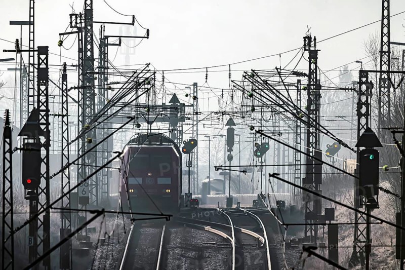 Deutsche Bahn AG tracks backlit with RegionalExpress. Overhead line, signals and infrastructure. Railway tracks at the Geislinger Steige, Alb ascent to the Swabian Alb. Amstetten, Baden-Württemberg, Germany