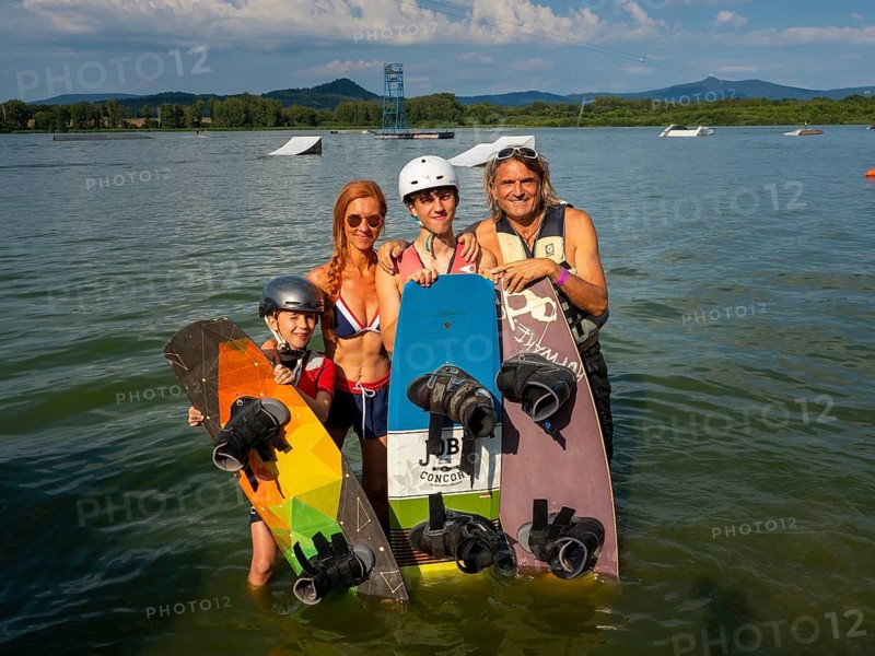 Family on summer holiday with wakeboards in the lake, water skiing and wake park, water sports, Stráž pod Ralskem, Czech Republic