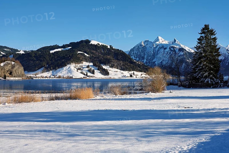 Frozen Sihlsee, reservoir, behind the snow-covered mountains Flübrig and Druesberg, Euthal, Canton Schwyz, Switzerland