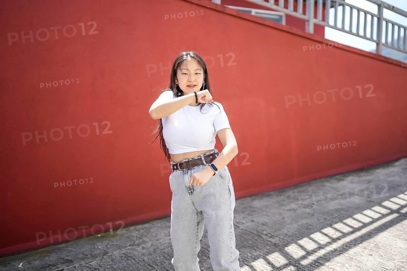 K-pop female asian young dancer performing in the street