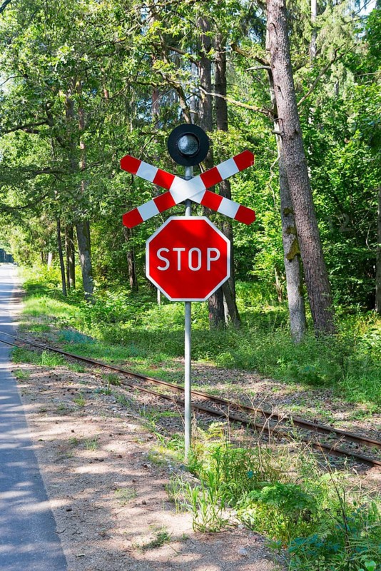 A red stop sign at a railway crossing in the forest, Suwalki, Podlaskie, Poland