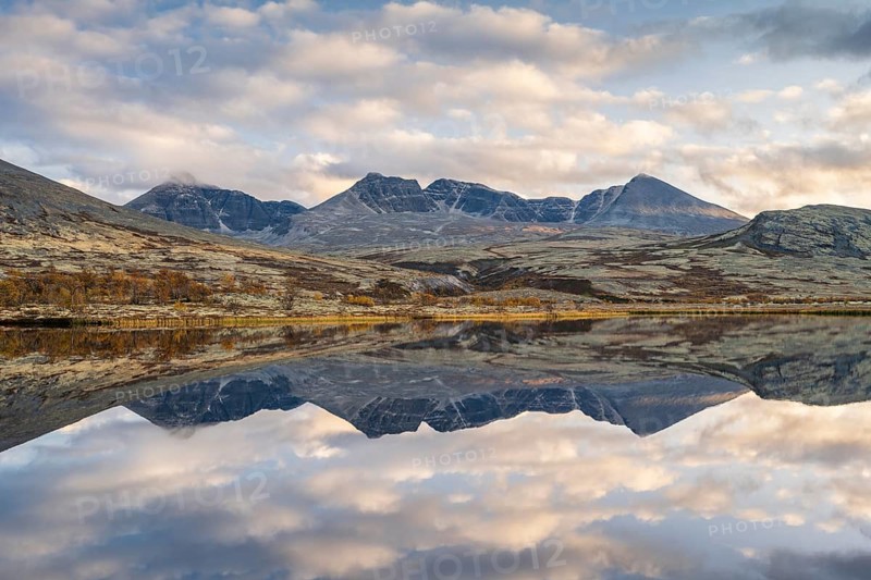 Reflection of the autumn landscape in Rondane National Park, mountains Høgronden, Midtronden and Digerronden Dørålen, Dørålseter, Norway