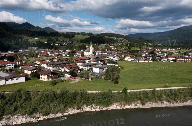 Drone shot, view of the village with parish church, Kössen, Leukental, Tyrol, Austria