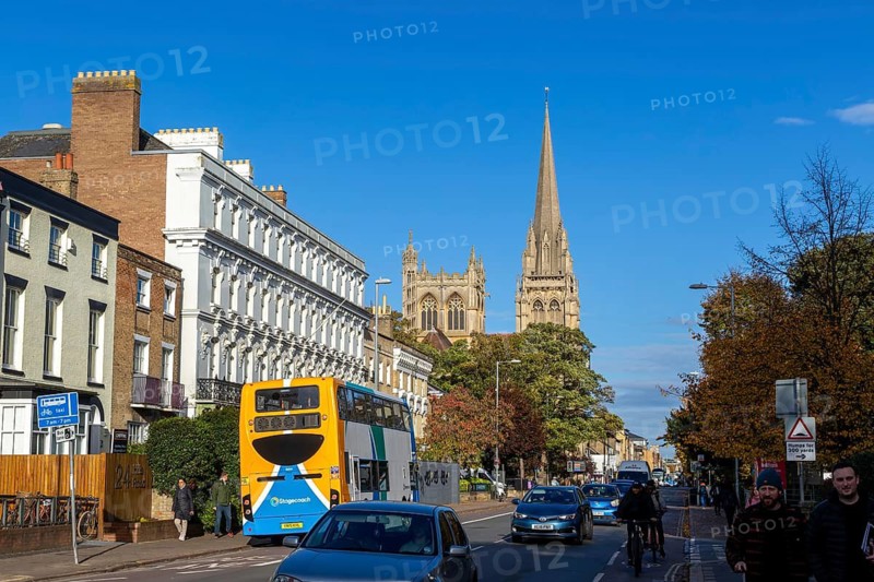 Traffic on Hills Road view to Roman Catholic church, Cambridge, Cambridgeshire, England, UK, listed buildings 12 to 18 Hills Road on left