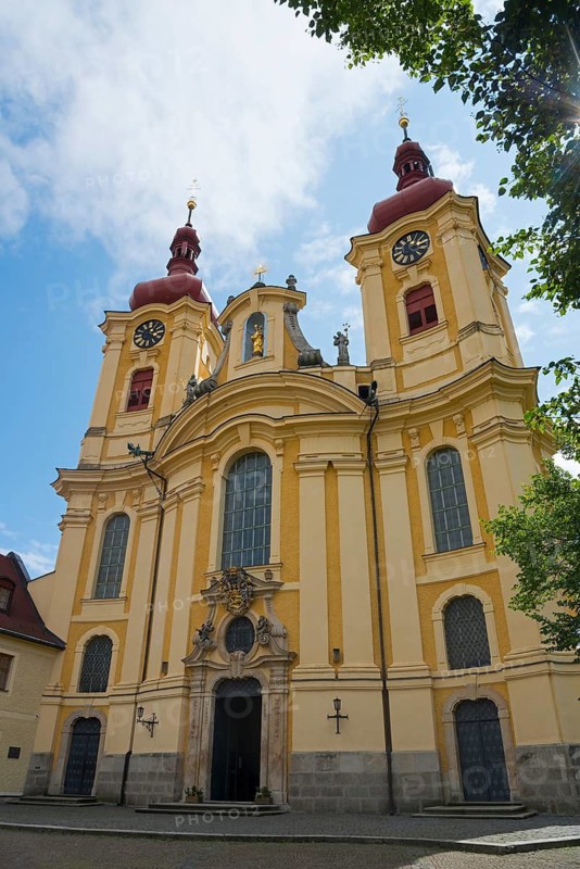 Detailed view of a baroque church with a yellow façade and red towers under a blue sky, pilgrimage church of the Visitation of Mary, Hejnice, Haindorf, Liberec, Czech Republic
