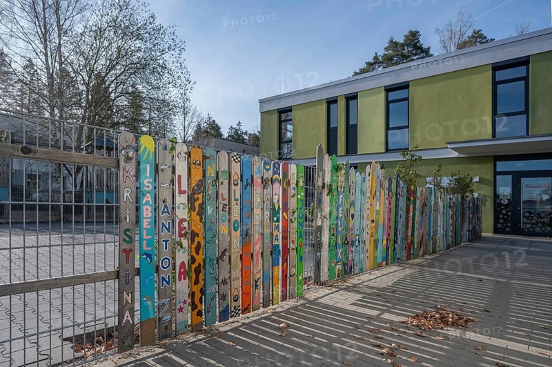 Colourfully painted fence, entrance to kindergarten, Wendelstein, Middle Franconia, Bavaria, Germany