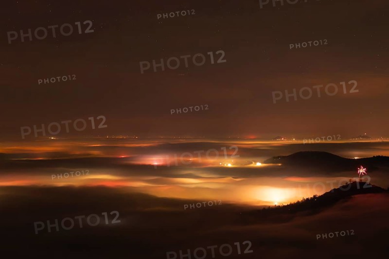 New Year's Eve fireworks 2024 on the Breitenstein, Swabian Alb near Ochsenwang. Sea of fog in the foothills of the Alb. View of the Drei Kaiserberge near Göppingen. In the foreground the Limburg and the Aichelberg