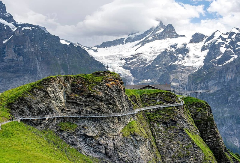 Tourist attraction First Cliff Walk, metal trail on a rocky outcrop, Grindelwald First, in front of impressive mountain landscape with Schreckhorn summit and Upper Grindelwald glacier, Bernese Alps, Bernese Oberland, Switzerland