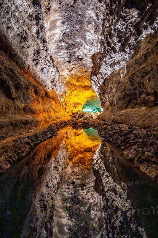 Lava tunnel, illuminated lava cave with perfect reflection in an underground lake, Cueva de los Verdes, Lanzarote, Canary Islands, Spain