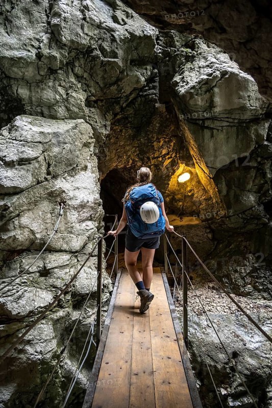 Hiker in a tunnel, Hammersbach flows through Höllentalklamm, near Garmisch-Partenkirchen, Werdenfelser Land, Upper Bavaria, Bavaria, Germany