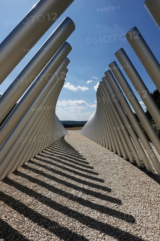 Art in public space, sculpture made of aluminum profile pipes by artist Martin Burchard, life's horizon path near Mundingen, light and shadow, gravel, clouds, blue sky, walk-in art, paths of reflection and refreshment on the Ehinger Alb, Baden-Württemberg, Germany