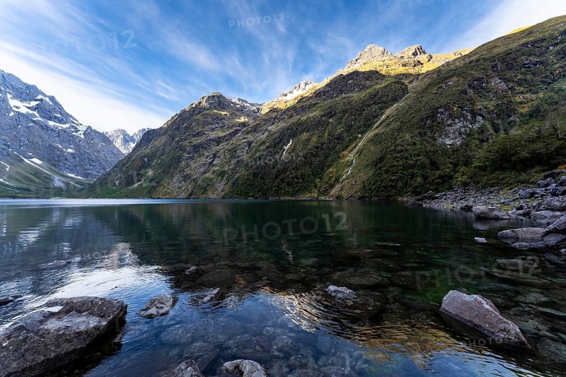 Landscape in New Zealand with mountains and lake. Lake Marian in the evening, Fiordland National Park, Southland Region, South Island, New Zealand