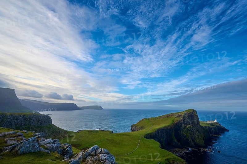 Breathtaking coastal scenery with steep cliffs, blue sky and a secluded lighthouse, Neist Point Lighthouse, Waterstein, Isle of Skye, Scotland, United Kingdom, United Kingdom