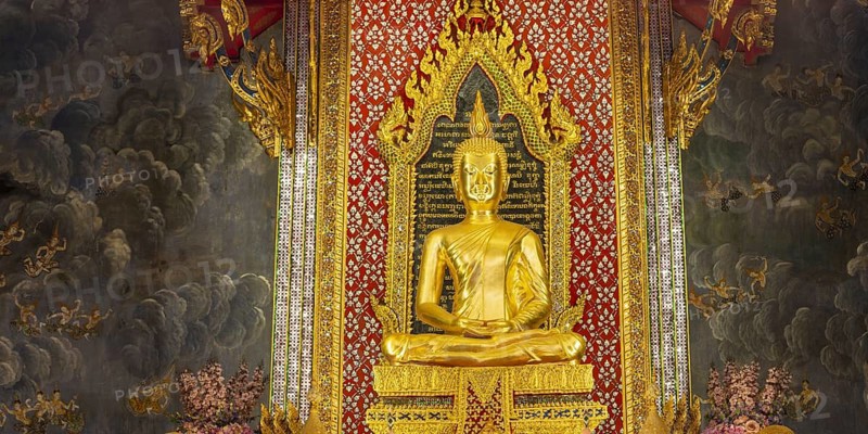 Golden meditating Buddha surrounded by wall paintings with Buddhist teachings and representations of Buddha's disciples, Wat Makut Kasatriyaram Ratchaworavihan, Phra Nakhon District, Old Bangkok, Thailand