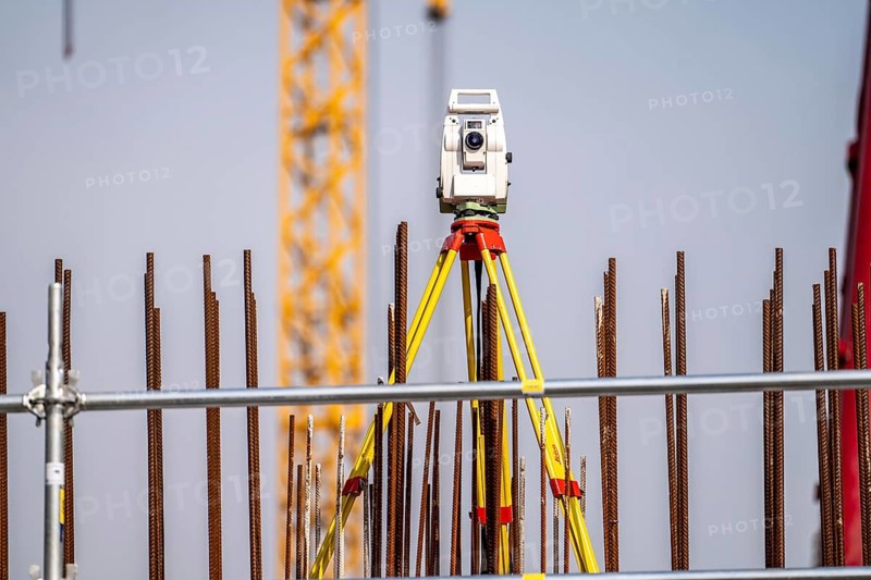 Surveying, Leica total station, electronic tachymeter, a surveying device that measures angles and distances electronically, for surveying terrain, buildings, construction sites, symbolic image