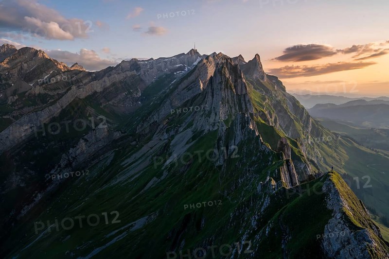 Stunning panorama of Altenalp Turm in Switzerland, capturing majestic peaks and lush valleys under a tranquil sunset sky, highlighting the beauty of the Swiss Alps