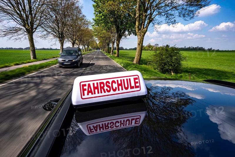 Symbolic picture driving school driving on a country road