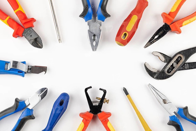 Various tools including pliers and screwdrivers arranged in a circle