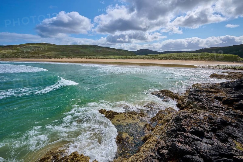 Coastal landscape with waves, rocks and sandy beach under blue sky with clouds, Farr Bay, Bettyhill, Thurso, Scotland, United Kingdom, Great Britain