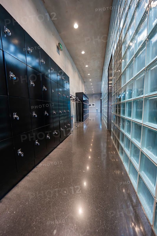 Modern corridor with black cloakrooms and glass wall, minimalistically lit, Kunsthaus Bregenz, Vorarlberg, Austria