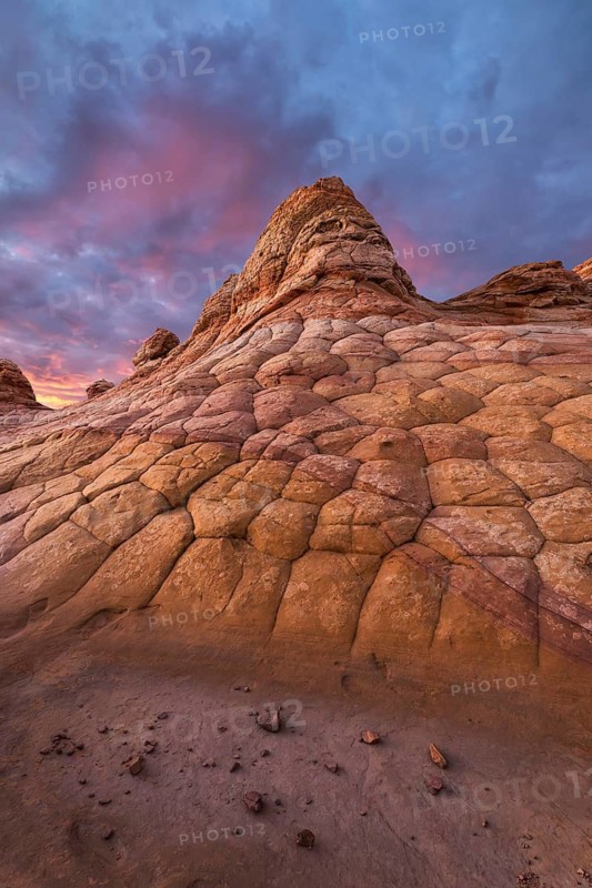 Vivid sunset over unique, textured sandstone formations at Coyote Buttes in the Paria Canyon-Vermilion Cliffs Wilderness, Arizona