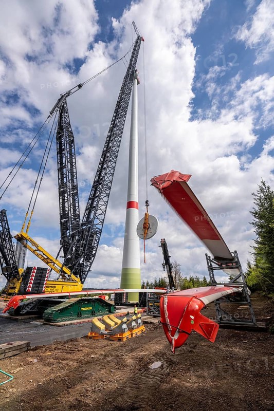 Erection of a wind turbine, wind energy plant, assembly of the ring generator, with a crawler lattice crane, wind farm near Hagen, North Rhine-Westphalia, Germany